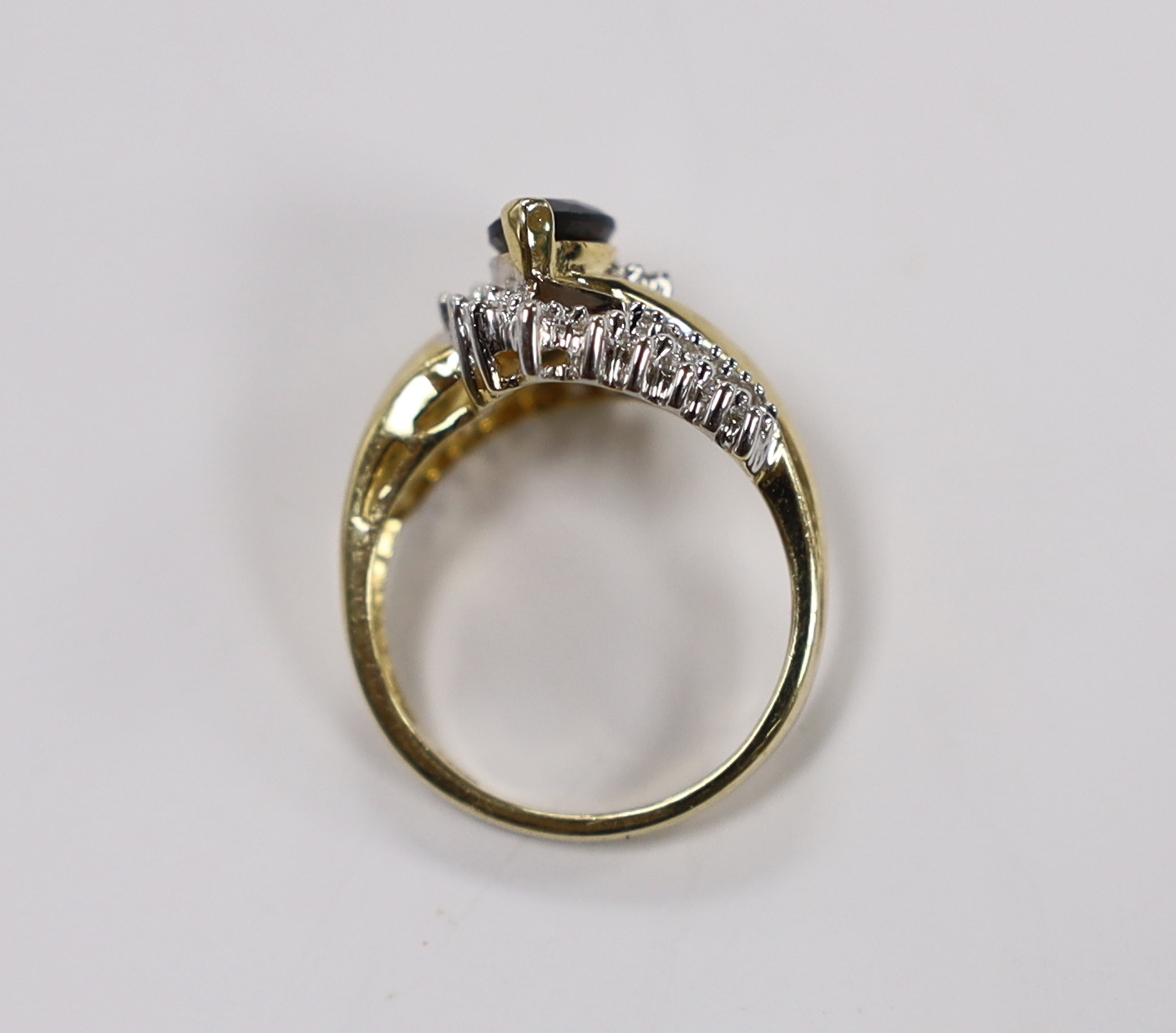 A modern 14kt, sapphire and diamond set crossover cluster ring, size M, gross weight 5.5 grams.